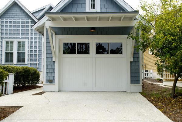 New custom carriage-style garage door with windows installed on Cameron Park residential home