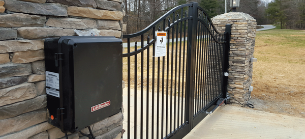 LiftMaster automatic swing gate opener freshly installed on stone gate pillar in El Dorado County