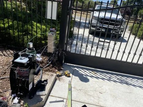Automatic gate opener motor unit being diagnosed and repaired by Elite technician