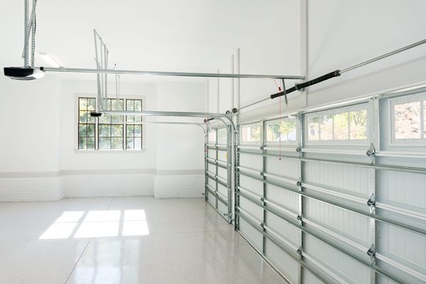 Non-insulated single garage door with windows viewed from driveway — garage door opener service